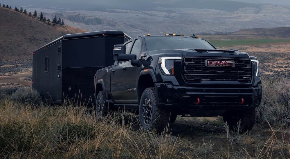 A black 2026 GMC Sierra 2500 HD towing a trailer.