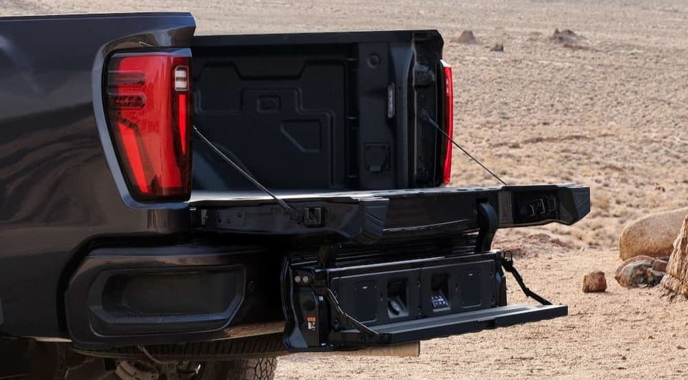Open tailgate on a black 2026 GMC Sierra 2500 HD.