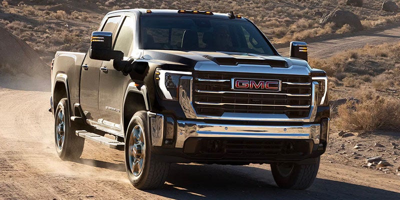 Black Sierra truck moving through a desert landscape