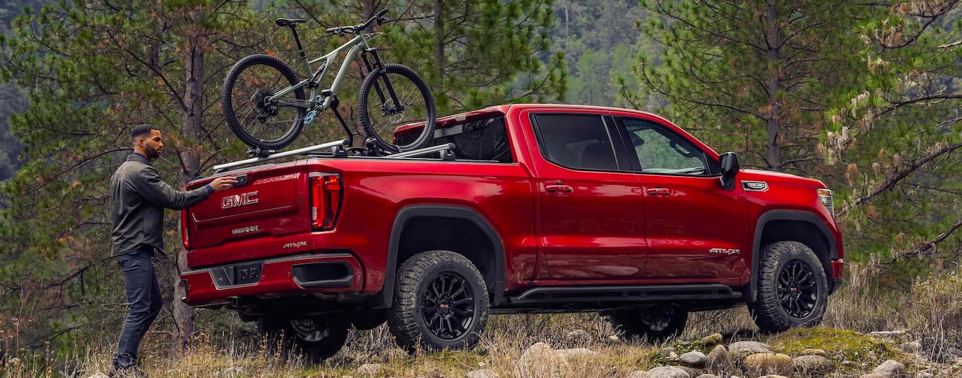 Rear of a red 2020 GMC Sierra 1500 parked off-road.
