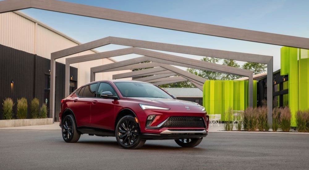 A red 2025 Buick Envista Avenir parked outside a building