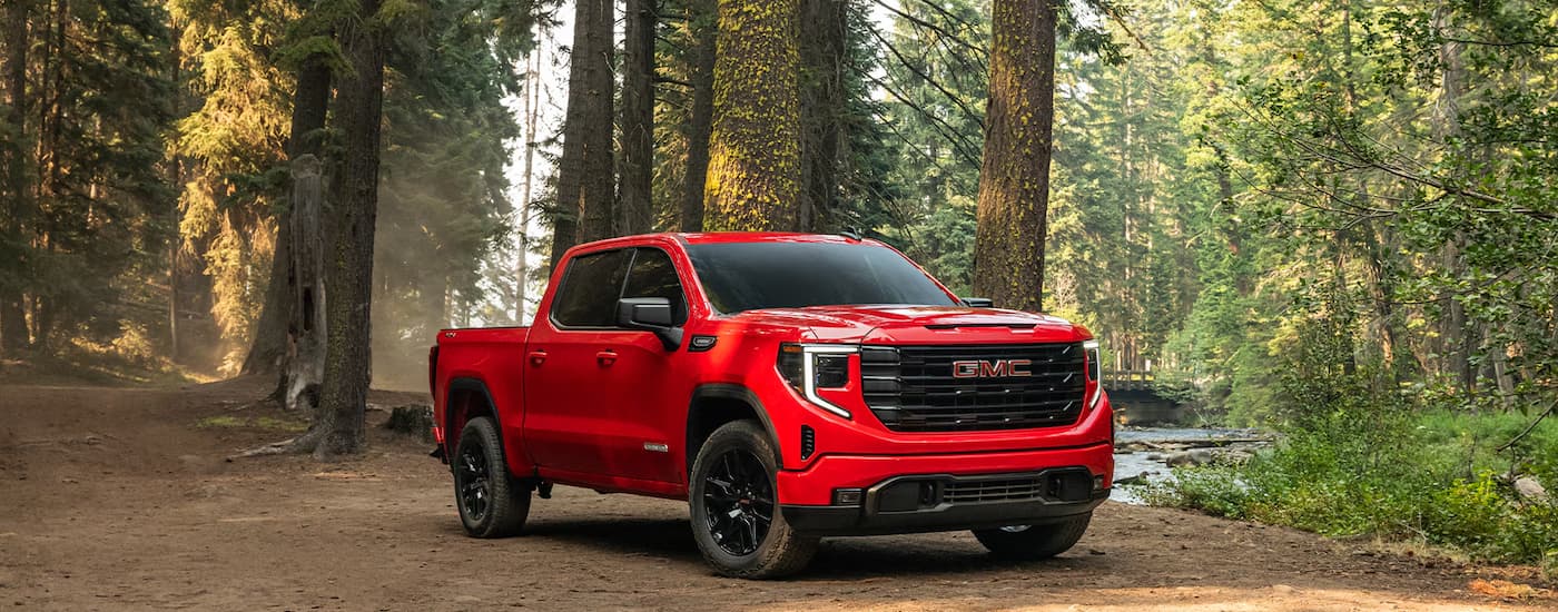 Red 2026 GMC Sierra 1500 parked in a forest