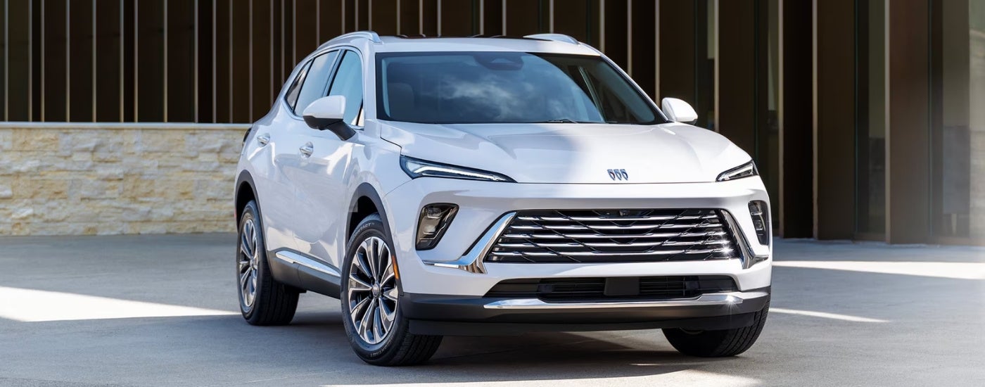 A white 2024 Buick Envision is parked on pavement after visiting a Buick dealer.