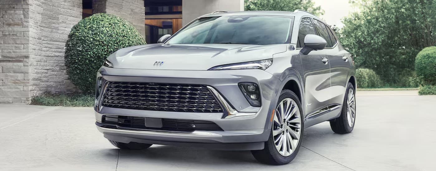 A silver 2024 Buick Envision Avenir parked on a driveway.