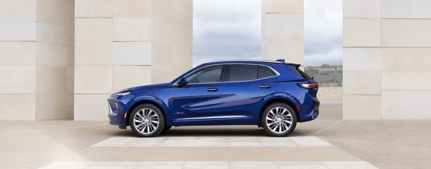 A blue 2025 Buick Envision parked in a modern building.