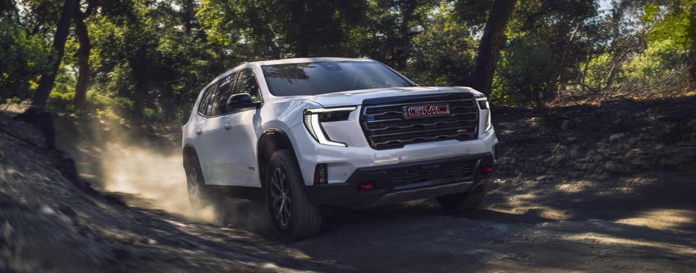 A white 2024 GMC Acadia AT4 is driving to GMC dealer near Mesquite.