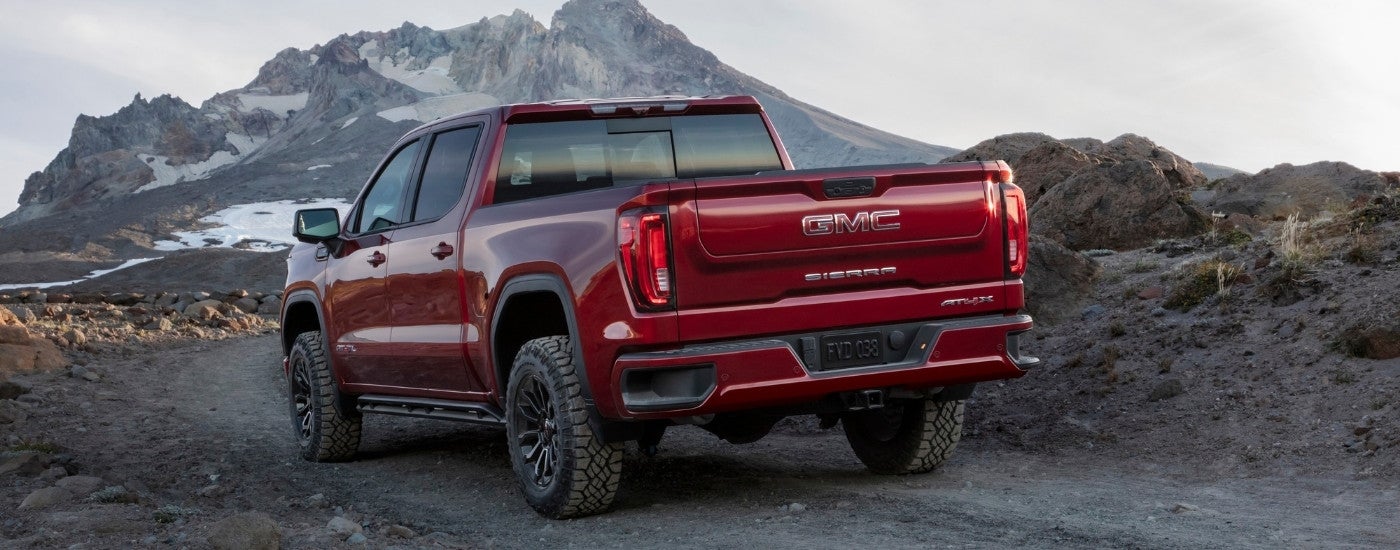 A red 2025 GMC Sierra 1500 AT4X from the rear at an angle.