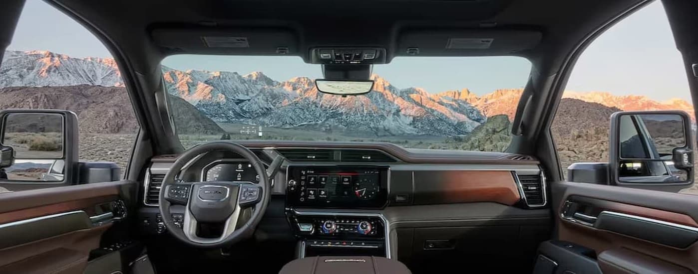 The black and brown interior and dash in a 2025 GMC Sierra 2500HD for sale near Rowlett.