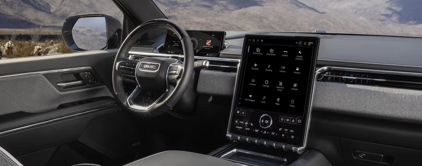 Infotainment display and digital gauge cluster in a 2025 GMC Sierra EV Elevation for sale near Wylie.