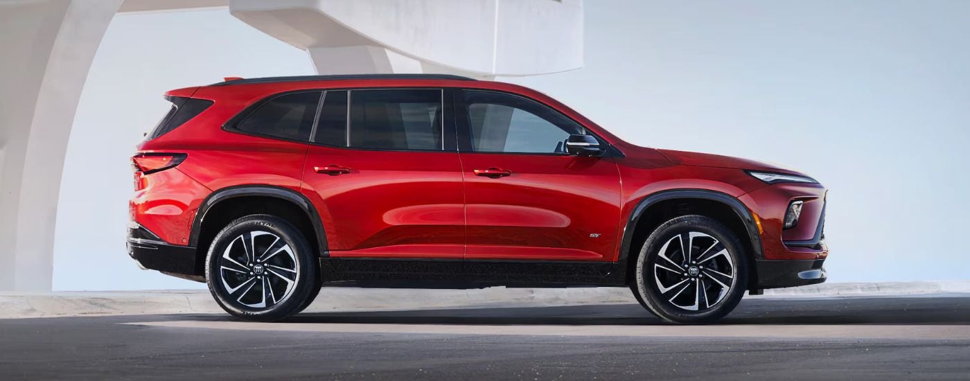 A red 2025 Buick Enclave ST parked off-road