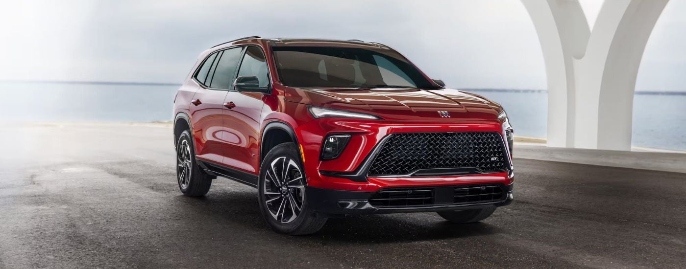 A red 2025 Buick Enclave ST parked off-road