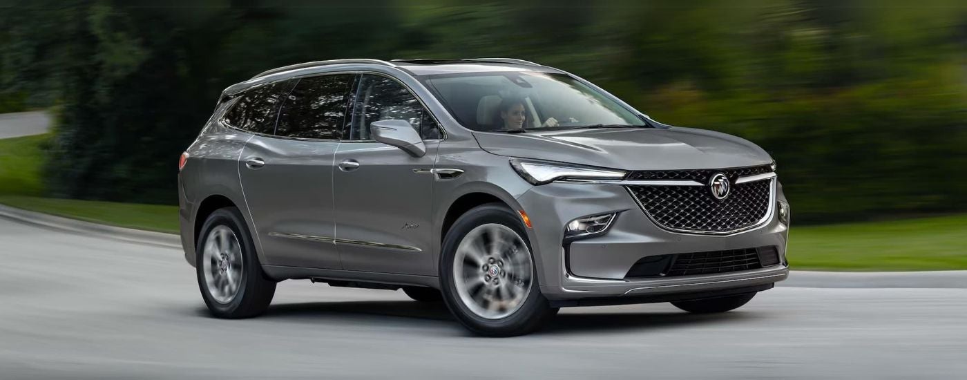 A gray 2024 Buick Enclave Avenir parked in a driveway