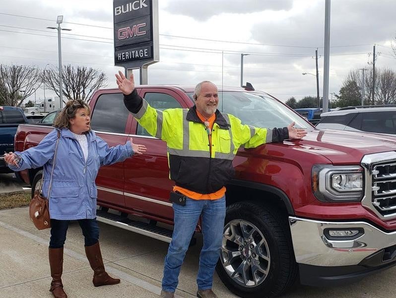 Woman and Man standing outside Heritage GMC Buick